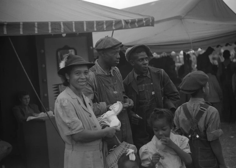 vintage black and white pograph of people holding baby