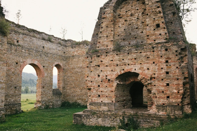 the ruins of an old castle, with many arches