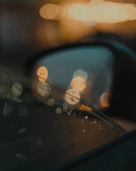 a po taken through the side mirror of a car at night