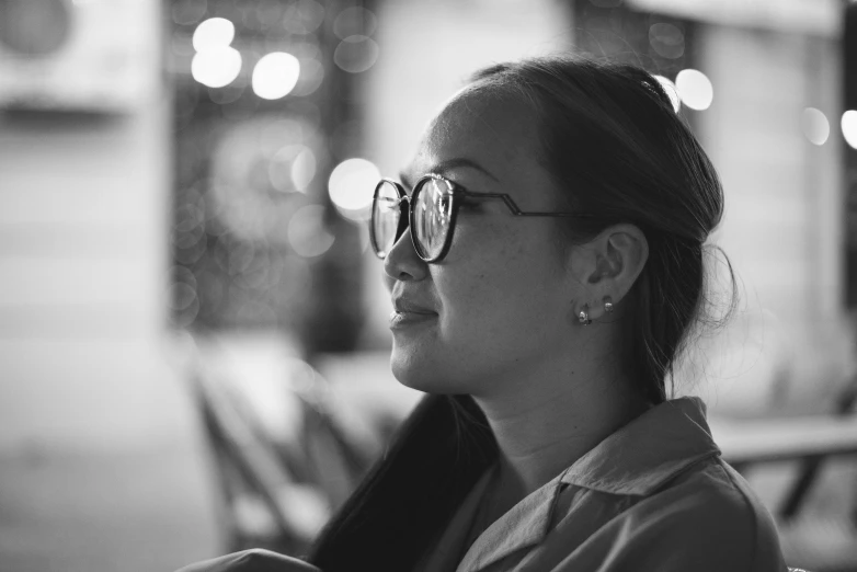 black and white po of a woman wearing glasses