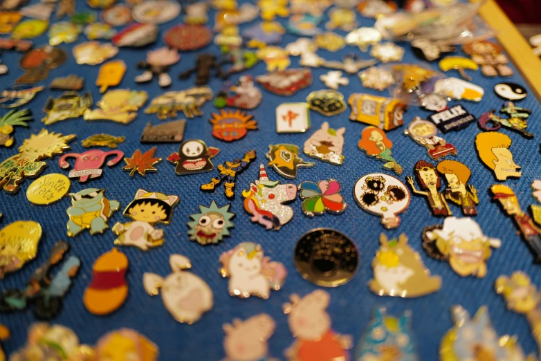 many different pins on a blue table cloth