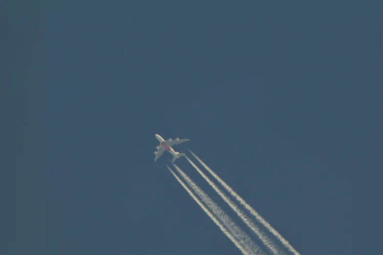 two jets flying very high in the blue sky