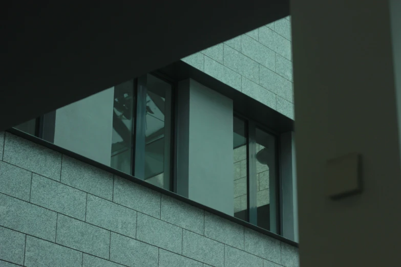 a glass block wall with windows that have been smashed open