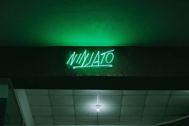 the neon sign is above the sidewalk