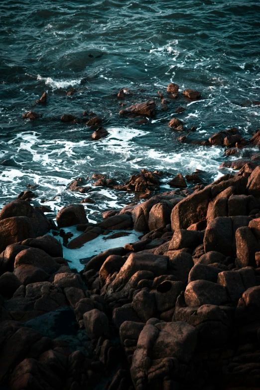 a rocky beach is shown with water and rocks