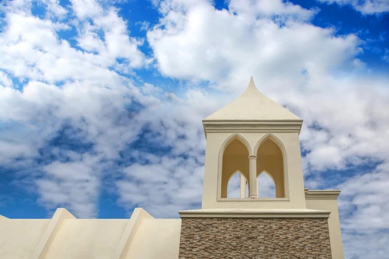 an interesting clock sits below some clouds in the sky