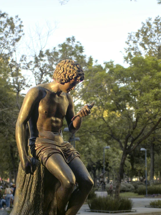 a statue of a man looking at his cellphone