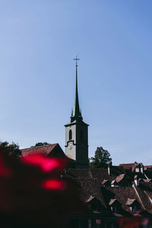 there is a building with a steeple and flower on the roof