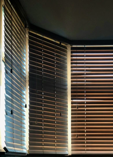 three light colored shutters covering a window