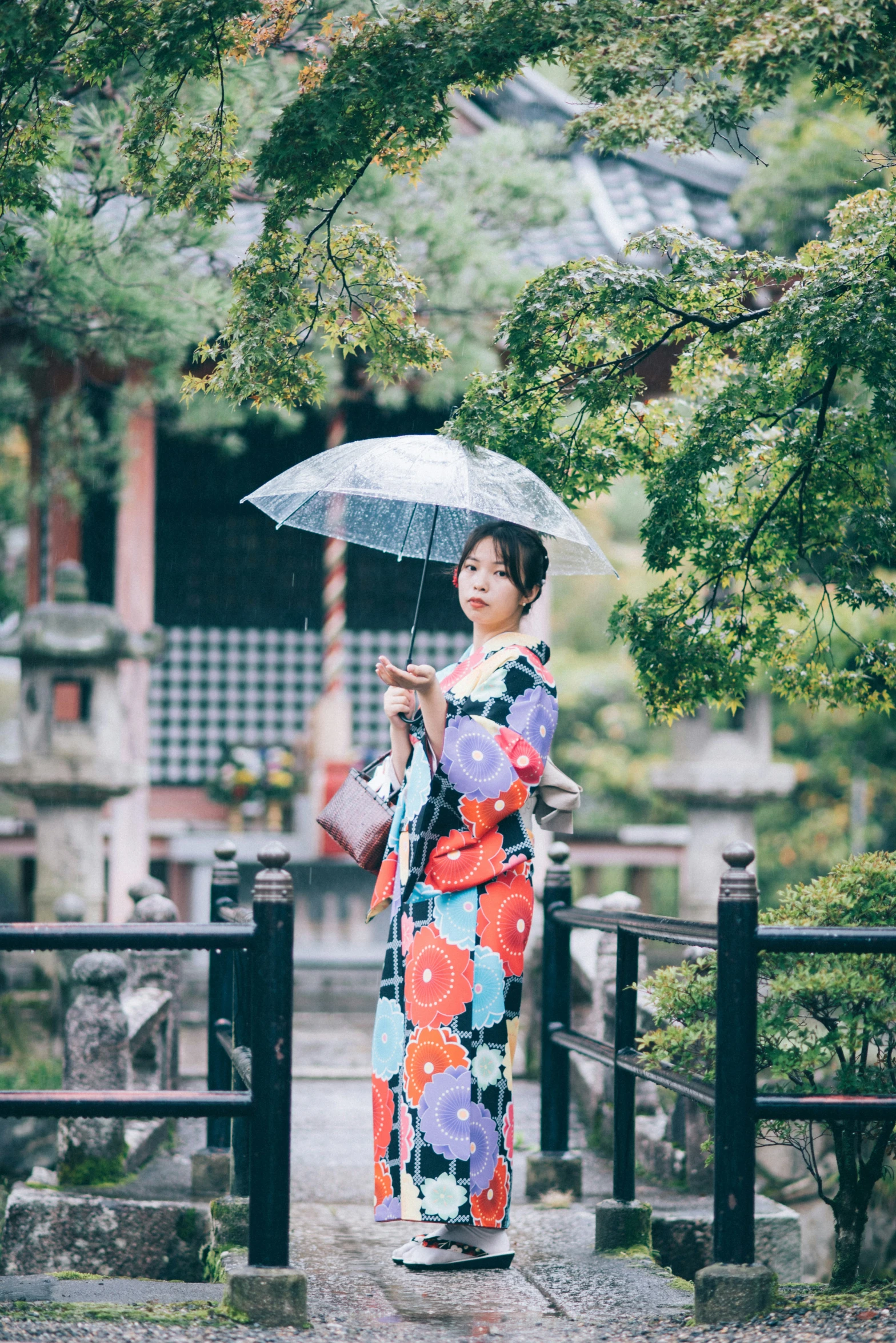 asian woman in the rain holding an umbrella