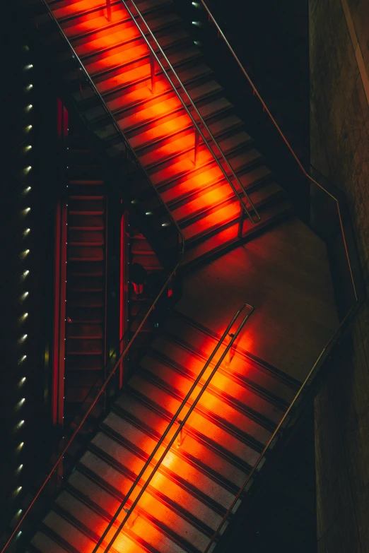 a stair case with the lights on glowing red