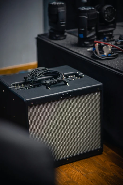 an amp that is sitting on the ground in front of a piece of equipment