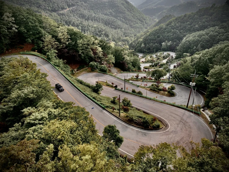 an aerial view of the winding mountain road