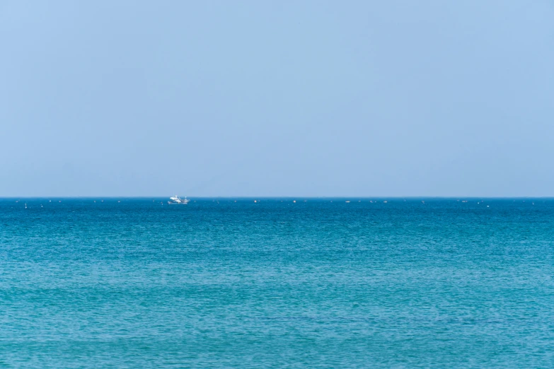 a sailboat in the blue water during a sunny day