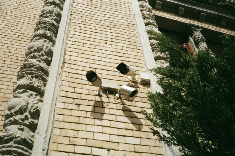 two street lights sitting on the corner of a brick building