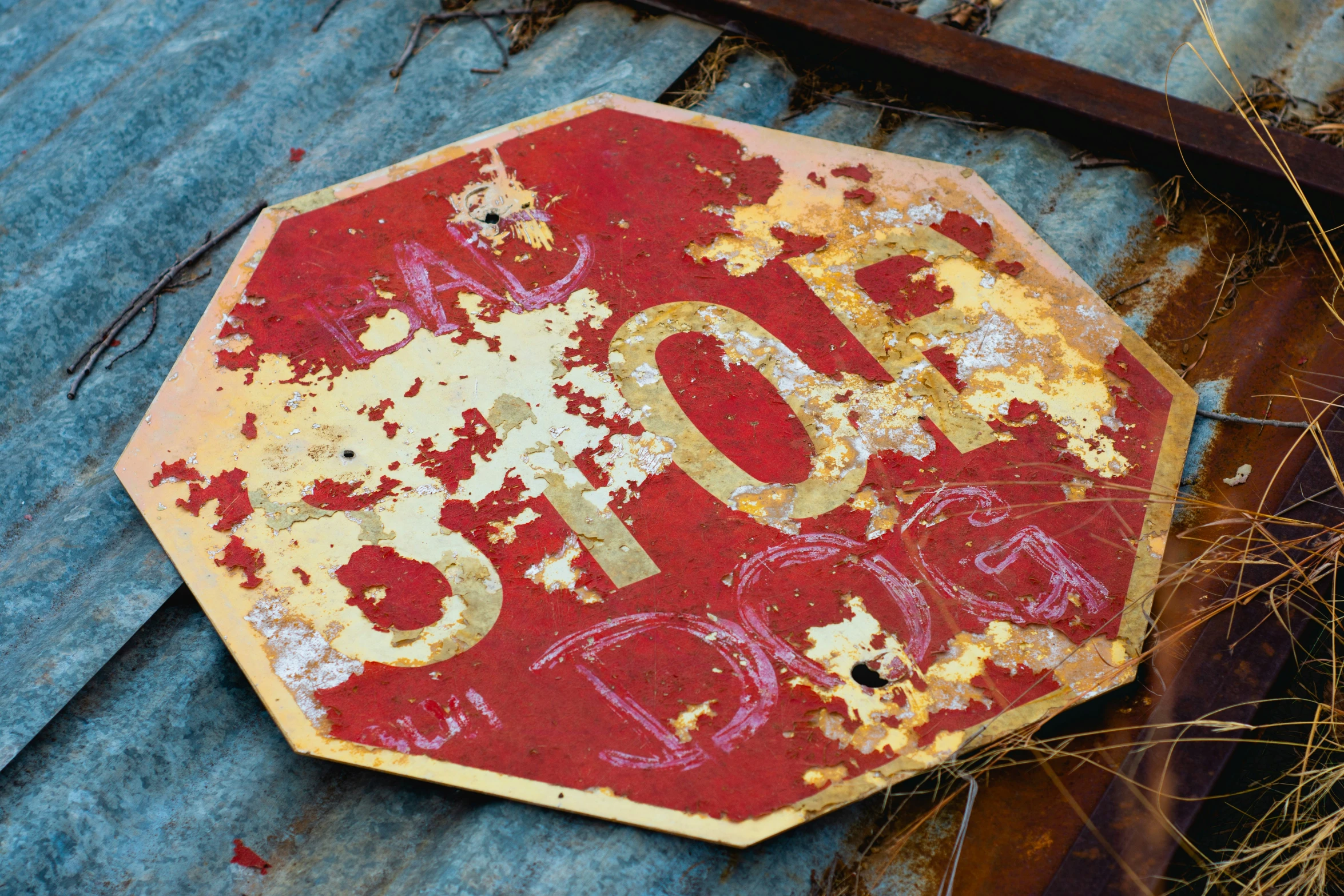 a stop sign that is falling on the ground