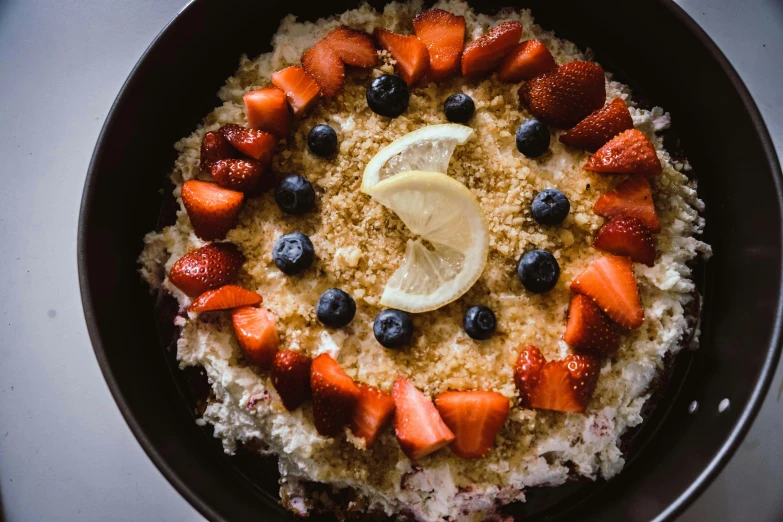 bowl full of oatmeal with fruit and lemon slice