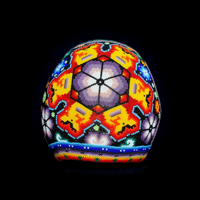 an illuminated decorative object on black background