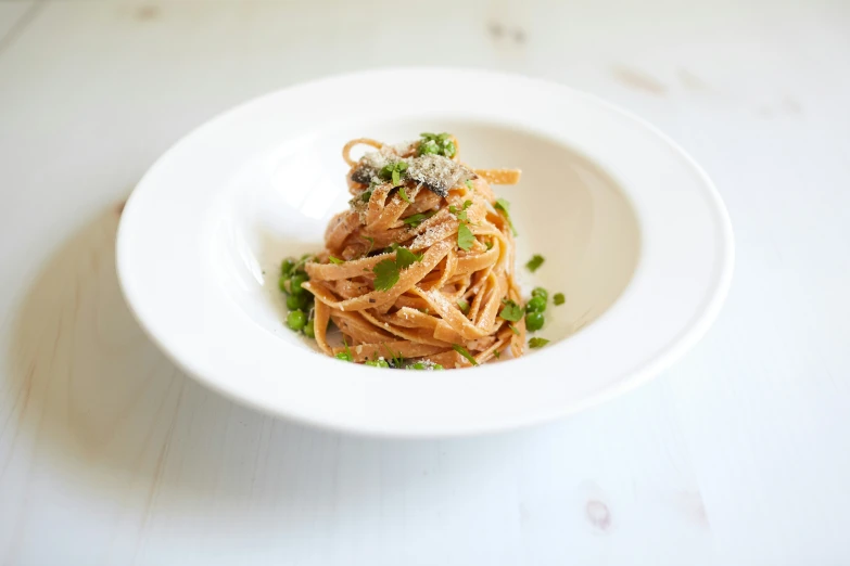 some food is in a bowl on a white surface