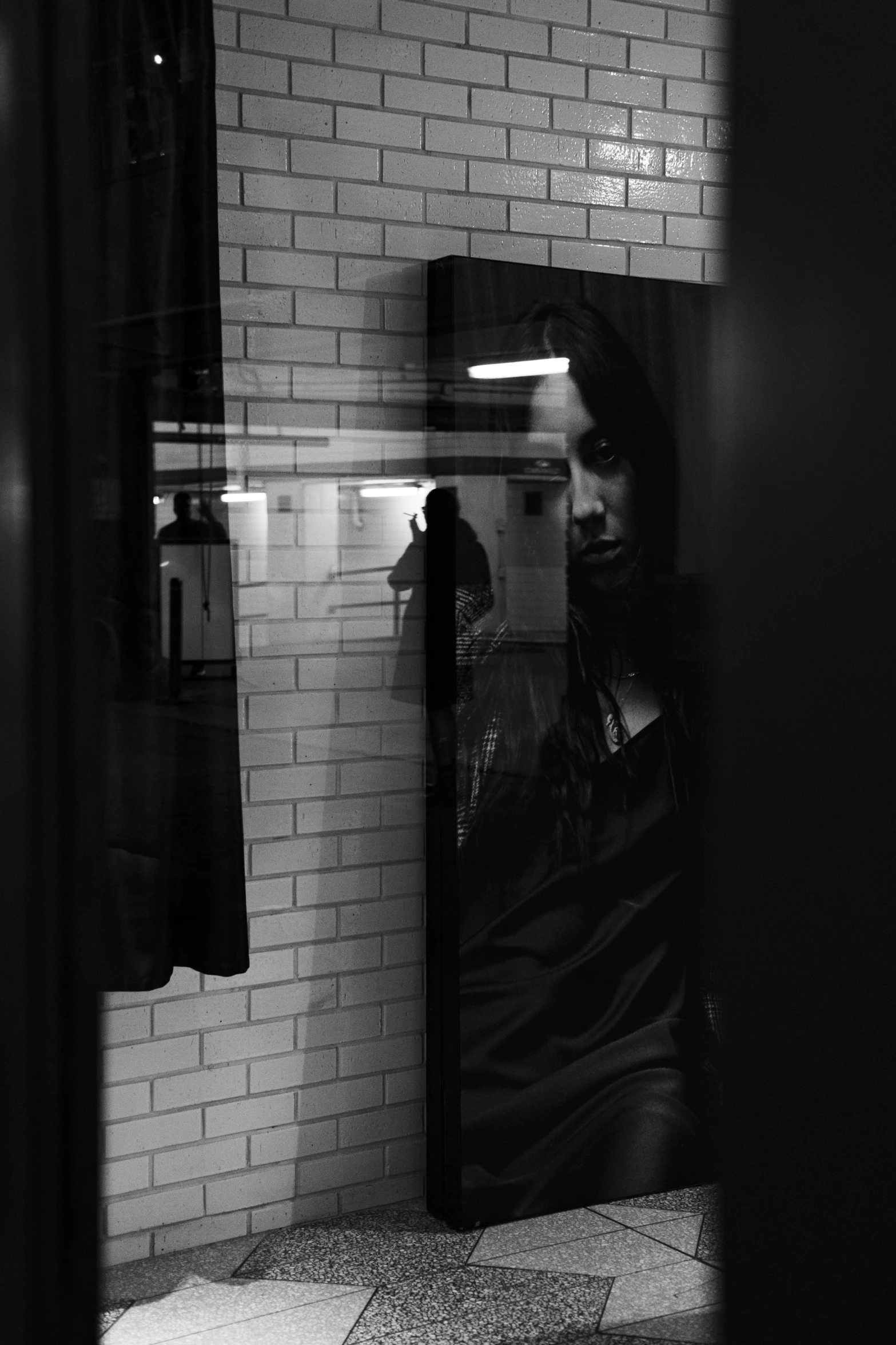 a man looking out a window at the sidewalk