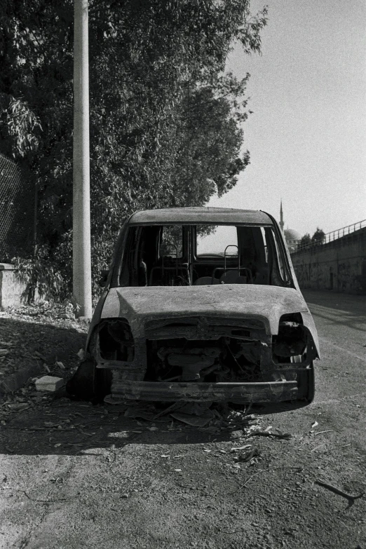 old rusty vehicle with dented front bumper in street