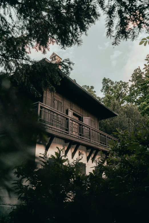 a house sitting next to some tall trees