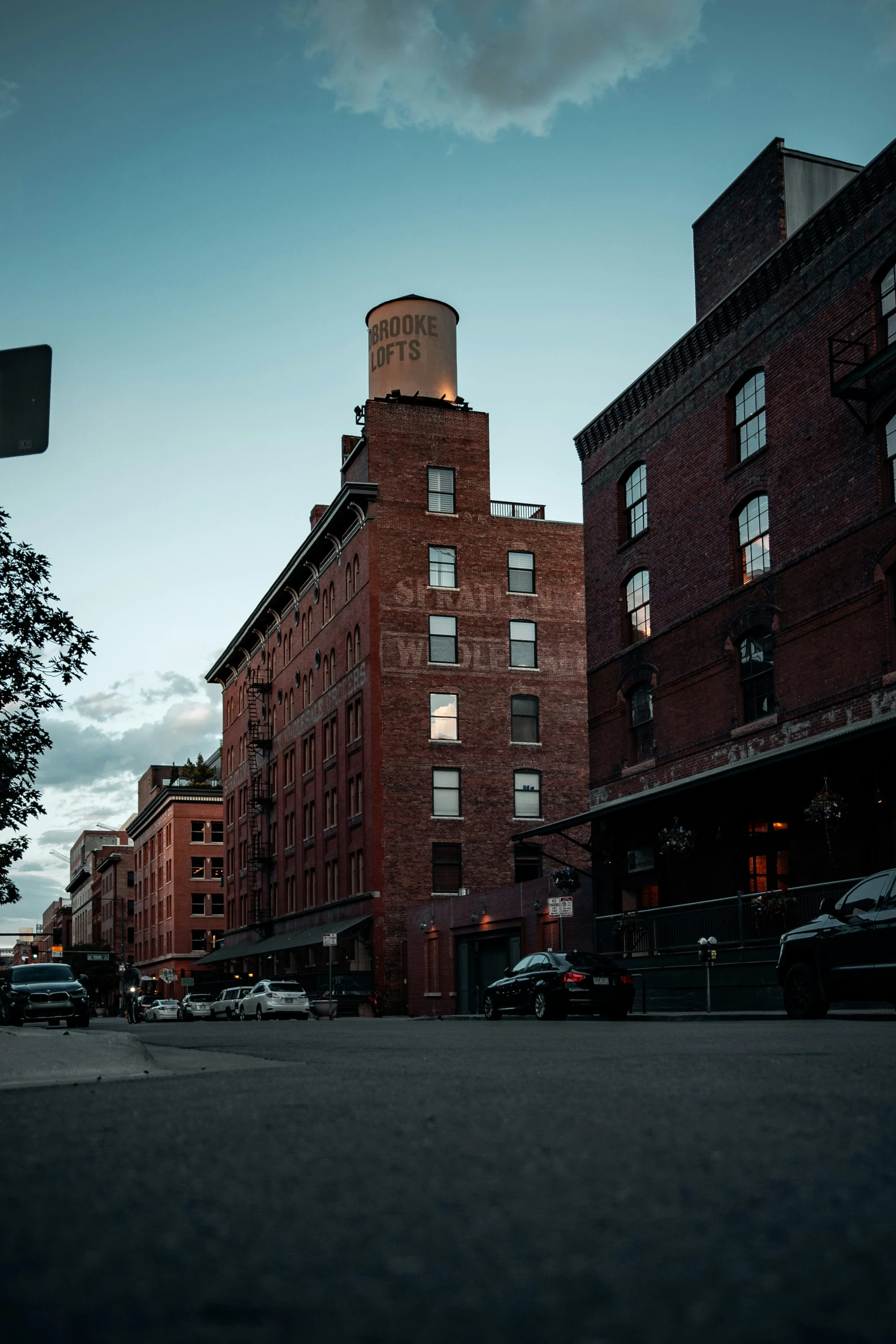 tall brick buildings stand along an empty street