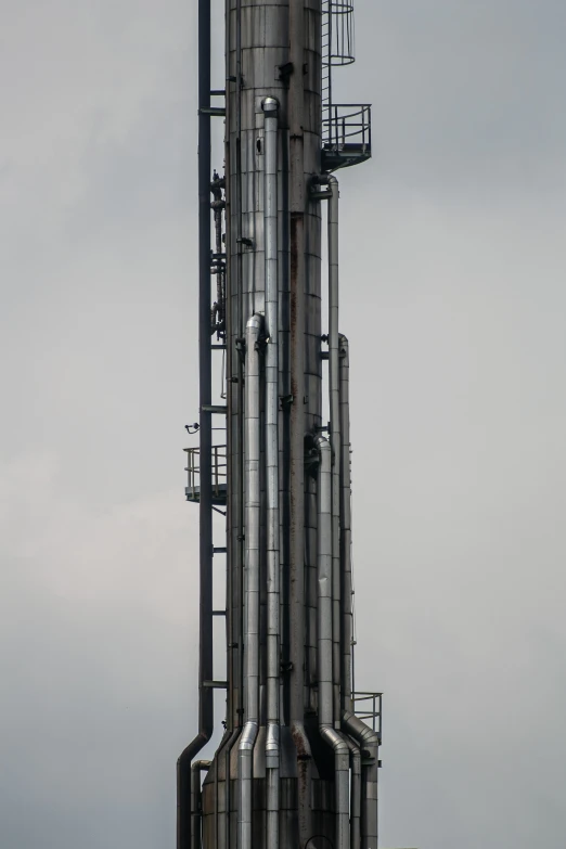 a jet plane flying over an industrial skyscr