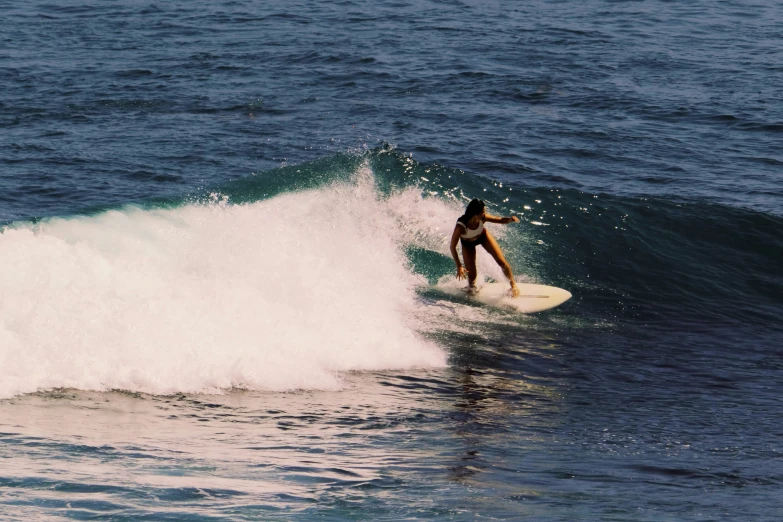 there is a person that is on the surfboard in the water