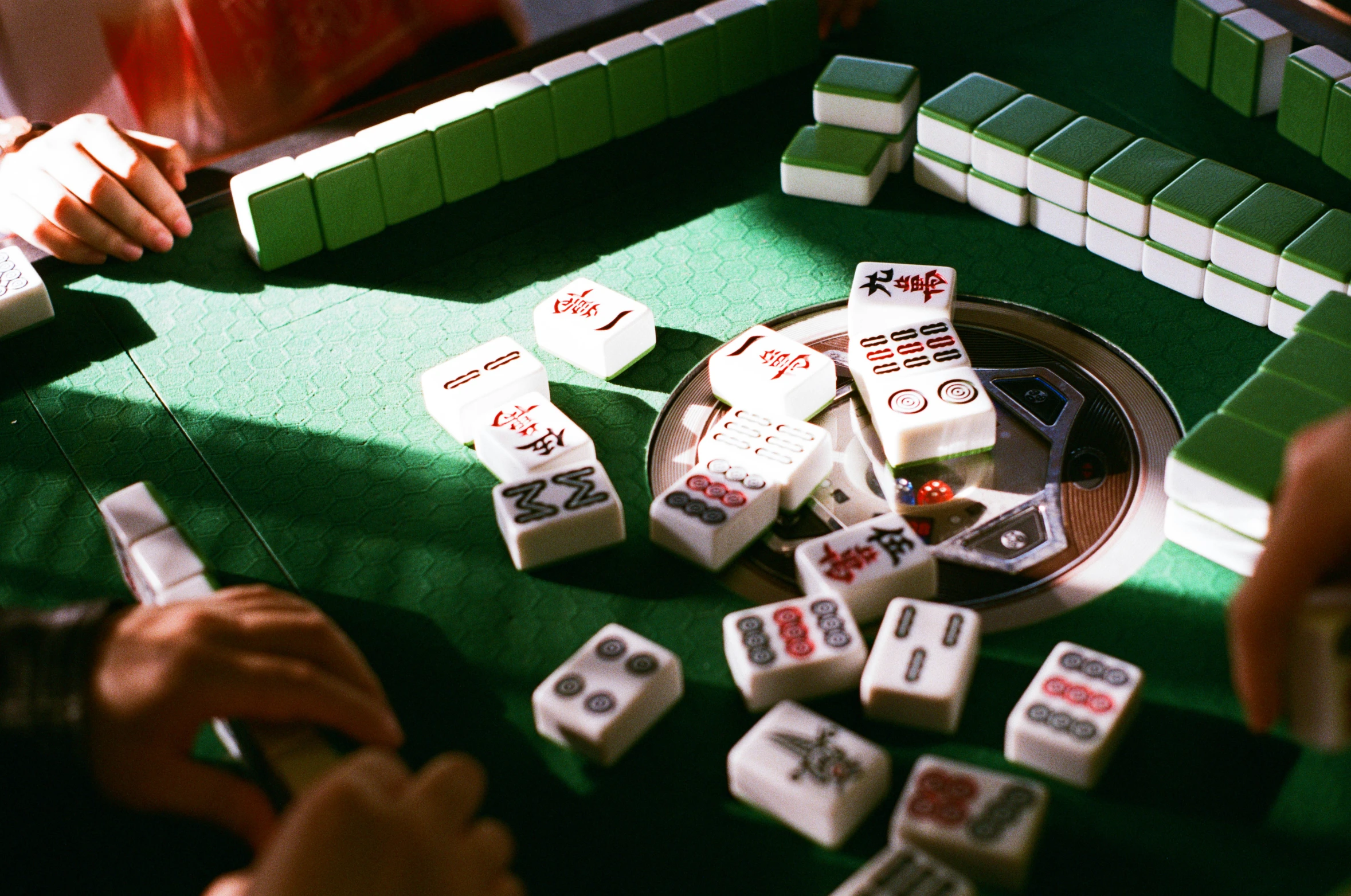 several people are playing with dominos and a gaming table