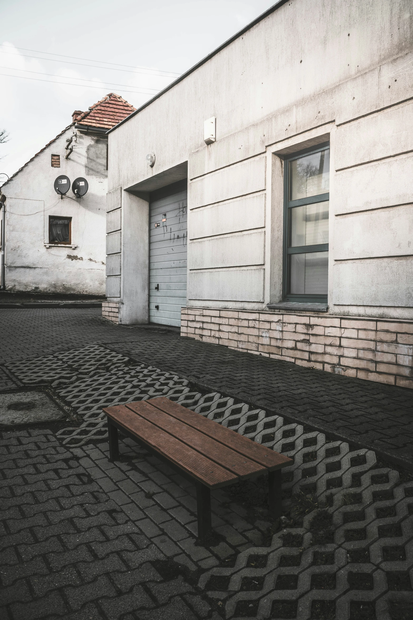a bench on an empty cobblestone street