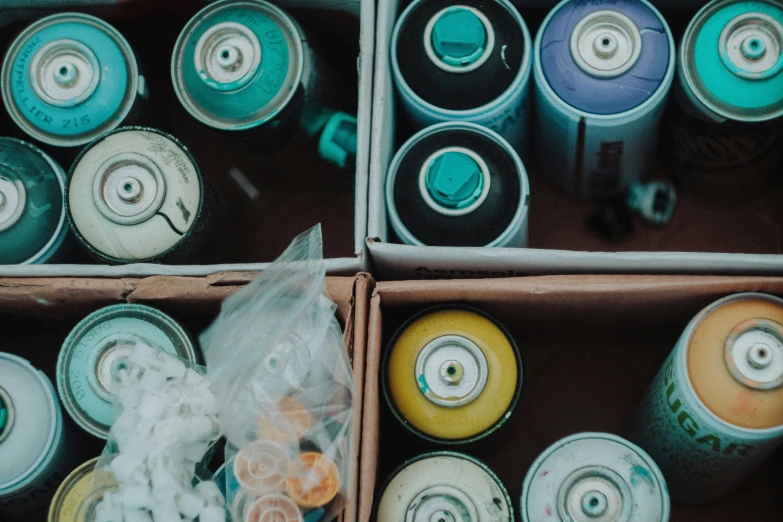 two rows of soda cans filled with different colored sodas