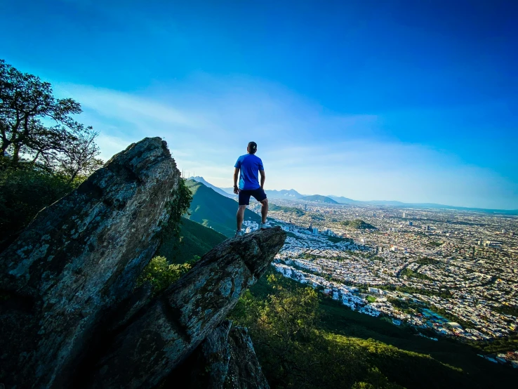 a person overlooking a city from a mountain top