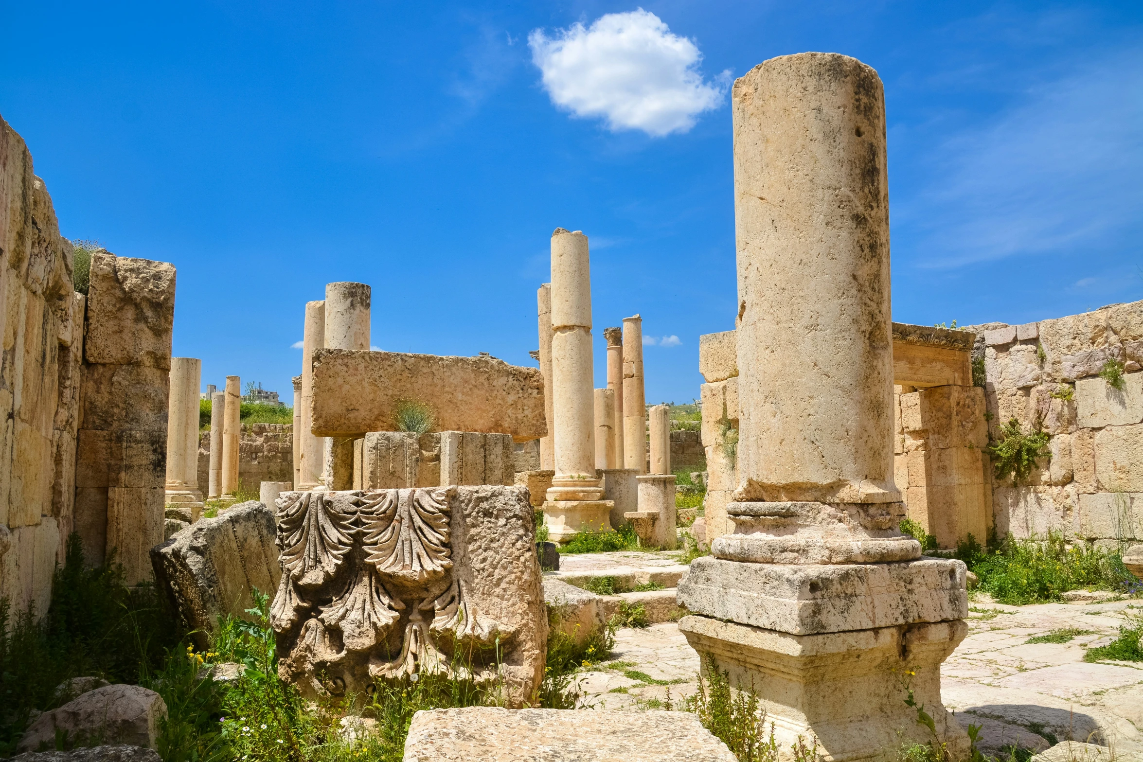 ruins of ancient buildings and other artifacts against a blue sky