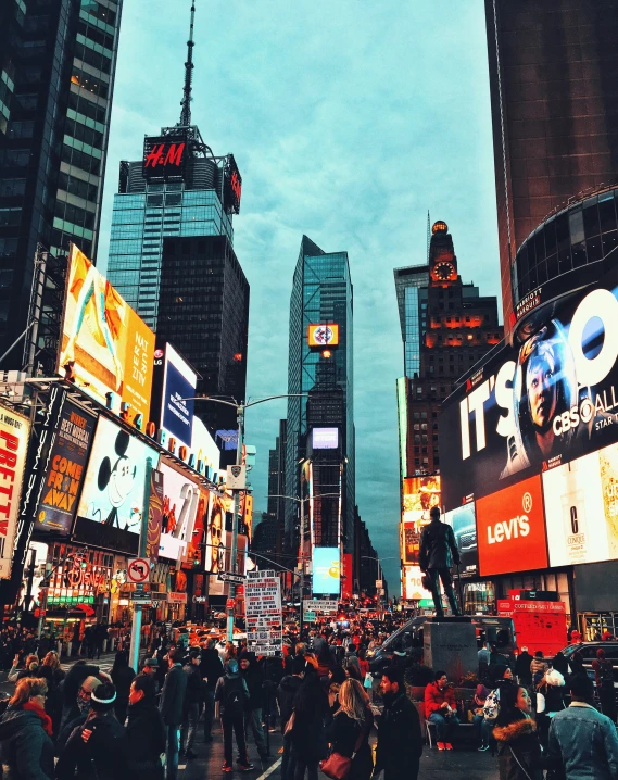 a cityscape with a lot of buildings and people standing around