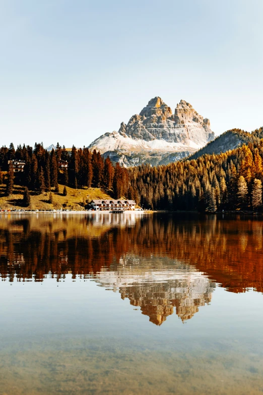 a mountain, with pine trees and a lake