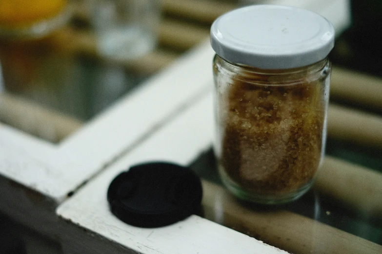 a close up of a glass jar and some food