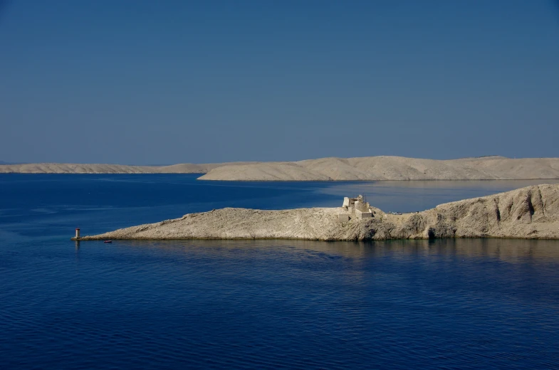 a rock outcropping on a body of water