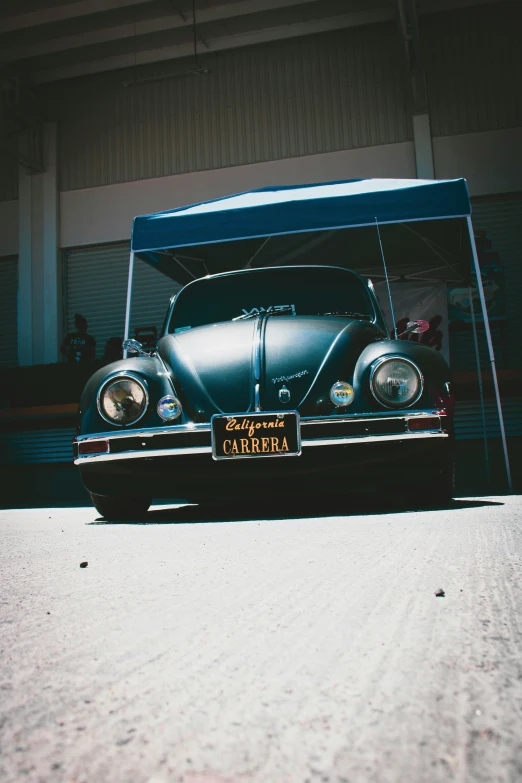 a blue car parked in front of a building