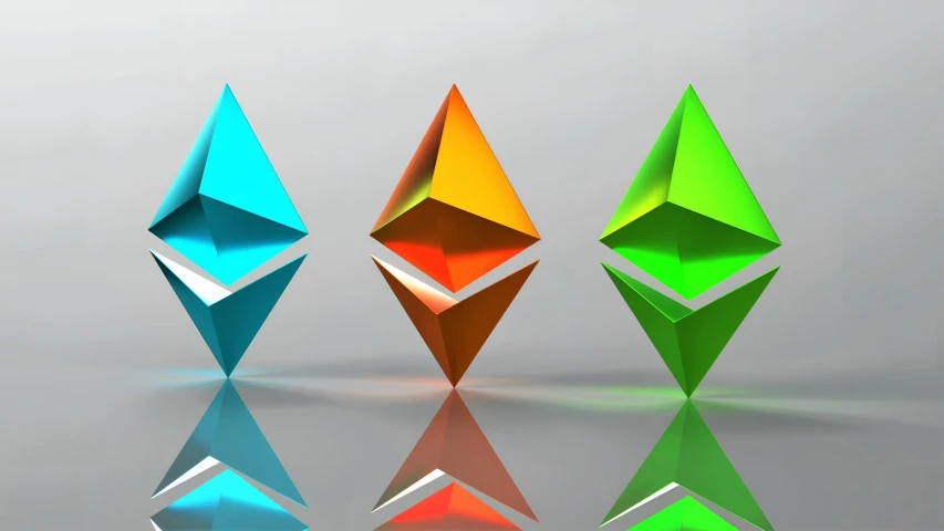 three colorful diamond shaped objects with reflection in water