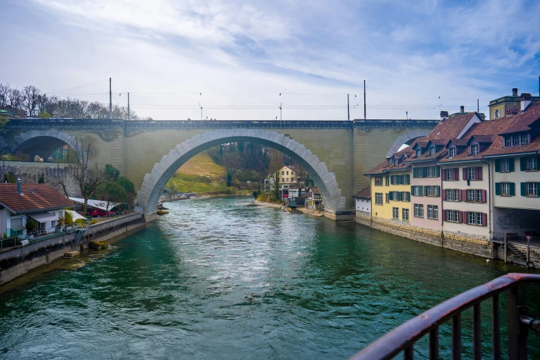 old buildings along a river and bridge over water