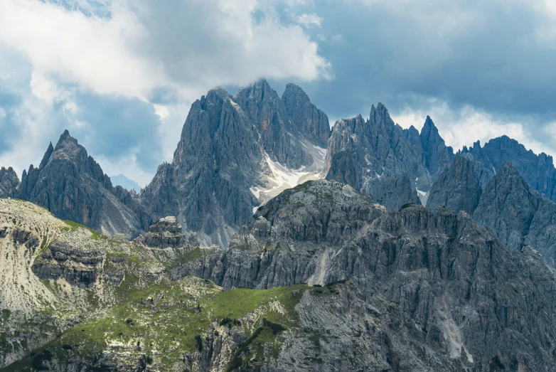 a very large mountain range in the background with snow on the peaks