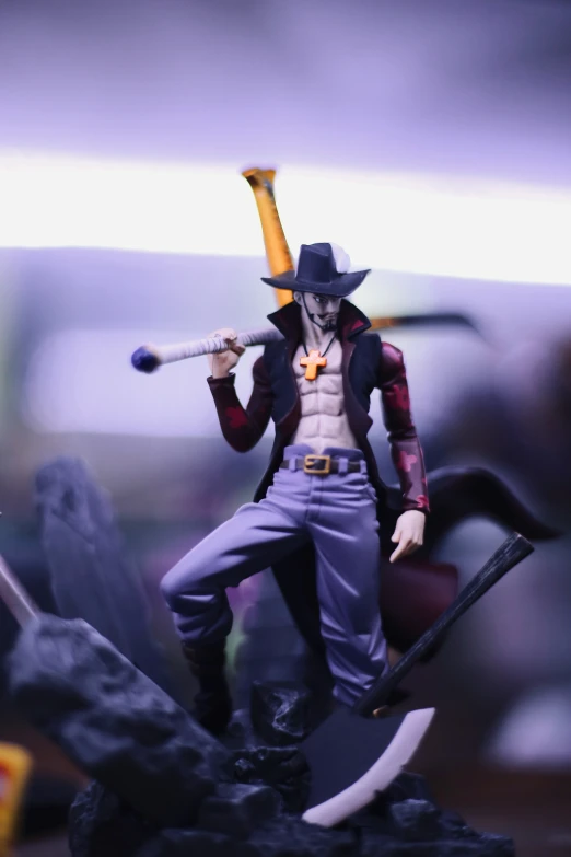 action figure holding baseball bat standing atop a small statue