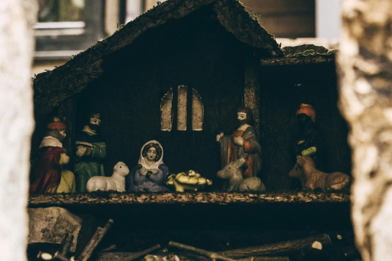 a nativity scene with figurines sitting in the window