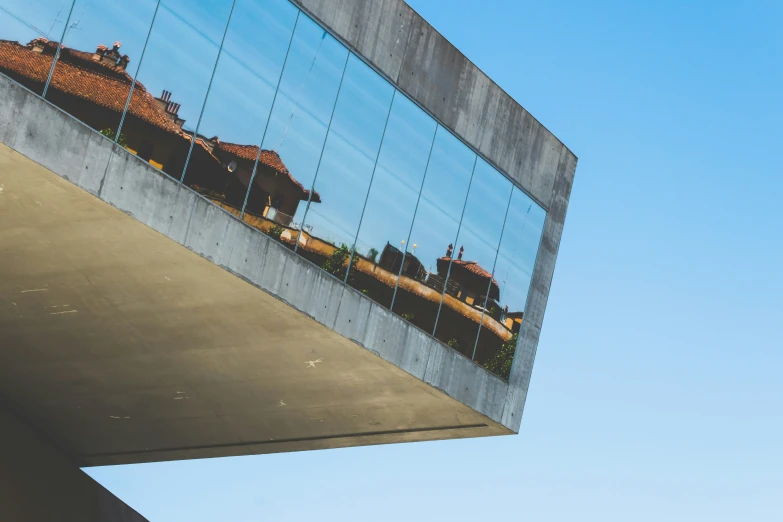 a large mirror reflects a couple of houses