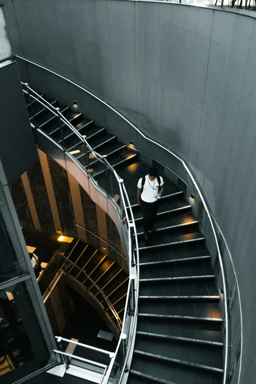 a spiral staircase in the building that is dark