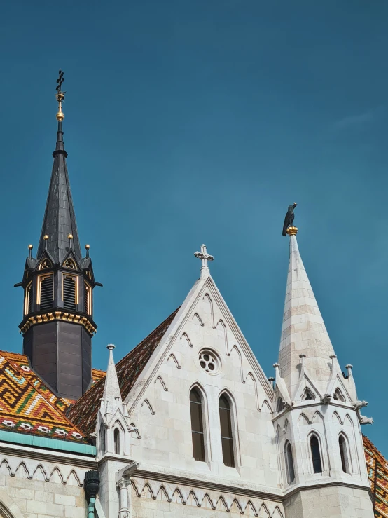 two roofs and spires on a building