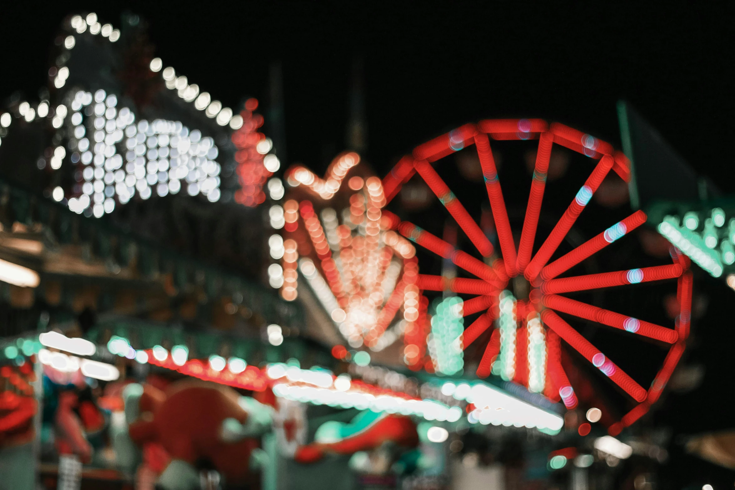 the rides at a carnival are colorful at night