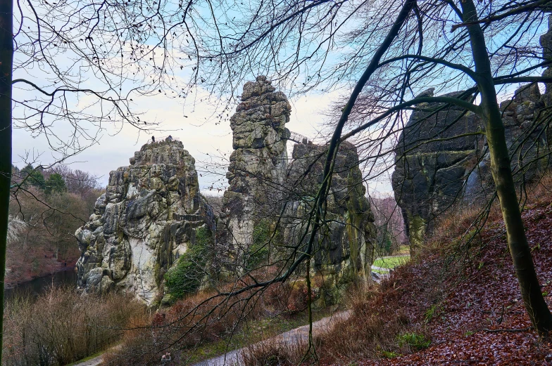 a very tall, green tower sitting on the side of a hill