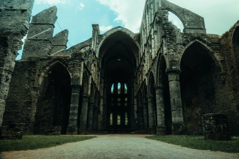 the entrance to a castle with stone pillars